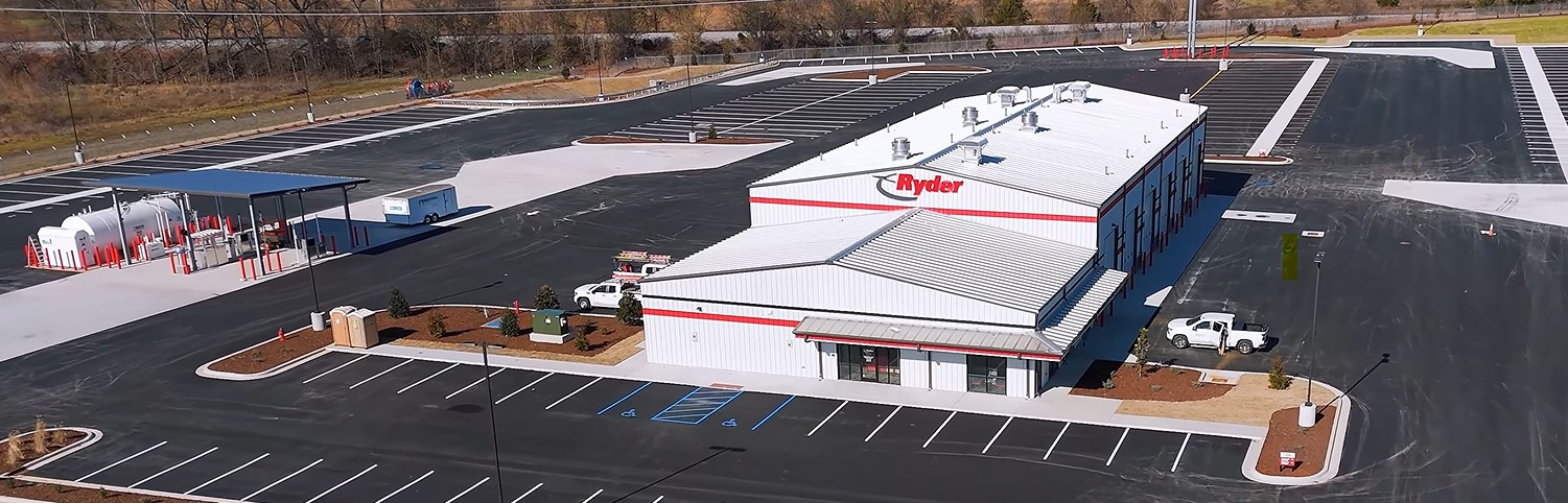Aerial view of Ryder commercial warehouse facility with white roof and red signage in industrial area