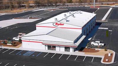 Aerial view of Ryder commercial warehouse facility with white roof and red signage in industrial area