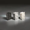 Three electrical outlet designs in black, white, and beige with dual socket configurations displayed on reflective surface