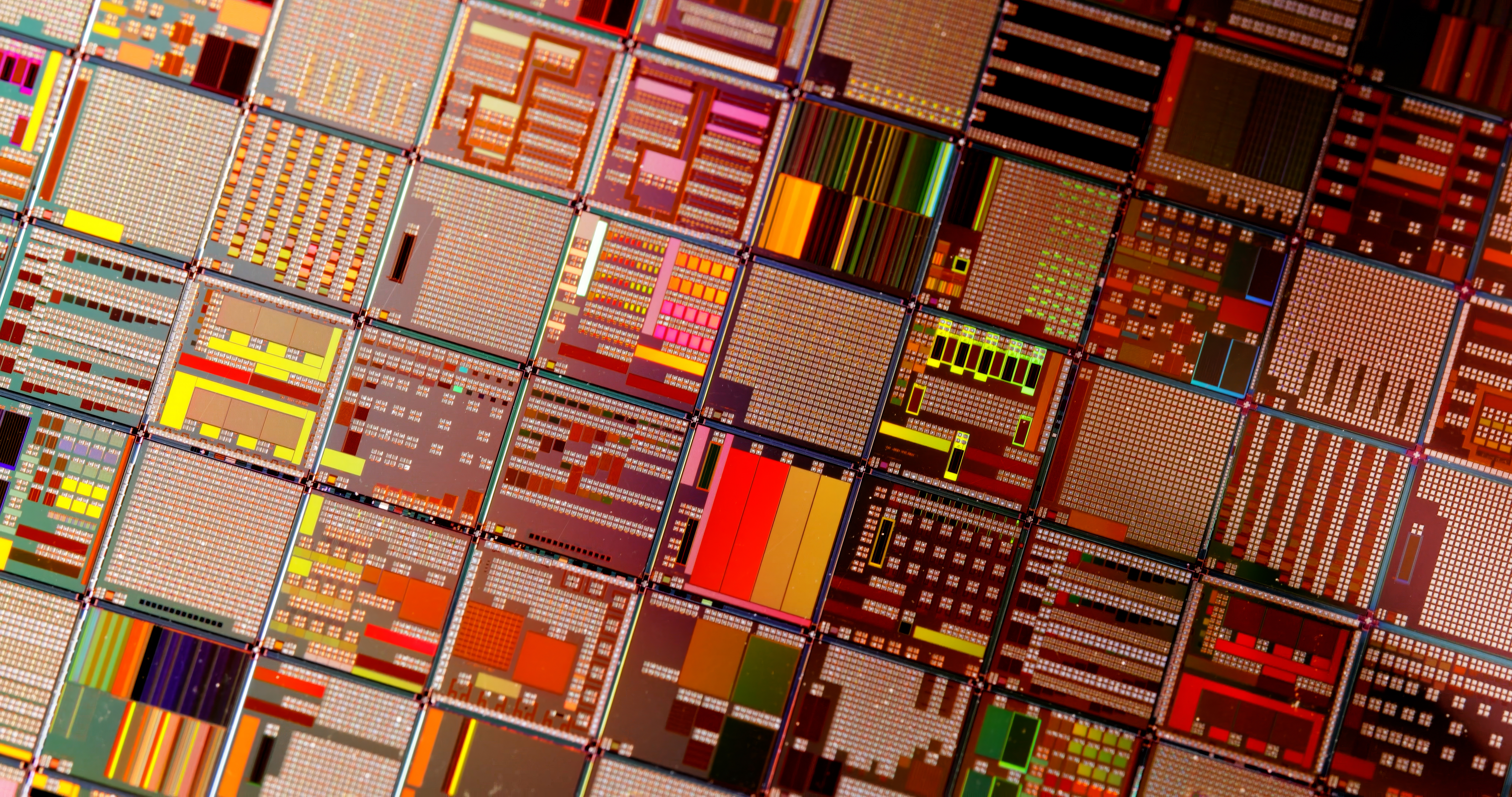 Grid of colorful circuit board layouts and microchip designs with geometric patterns