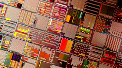 Grid of colorful circuit board layouts and microchip designs with geometric patterns
