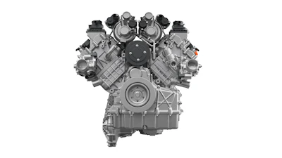 Front view of a symmetrical V-engine with dual overhead cams and four valve covers in grayscale technical illustration