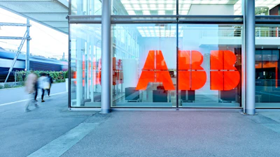ABB red logo signage on glass storefront with urban street and pedestrians