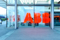 ABB red logo signage on glass storefront with urban street and pedestrians