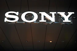 Sony illuminated sign displayed on dark ceiling with metal framework