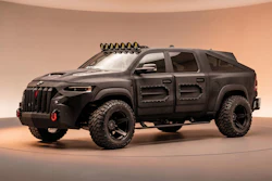 Black customized Jeep Grand Wagoneer SUV with open doors, roof rack, and tactical modifications on tan background