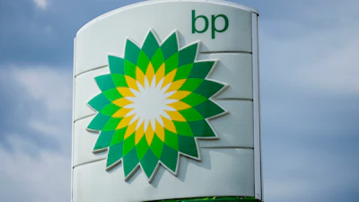 BP gas station sign with green and yellow sunburst logo against blue sky