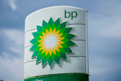 BP gas station sign with green and yellow sunburst logo against blue sky