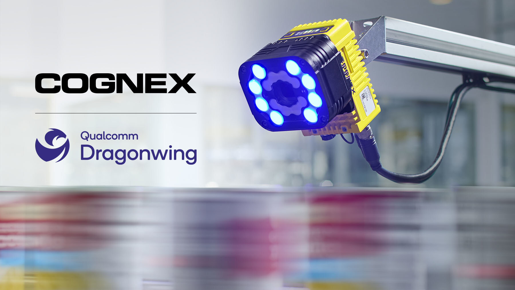 Cognex industrial blue LED machine vision light with yellow housing mounted on factory equipment