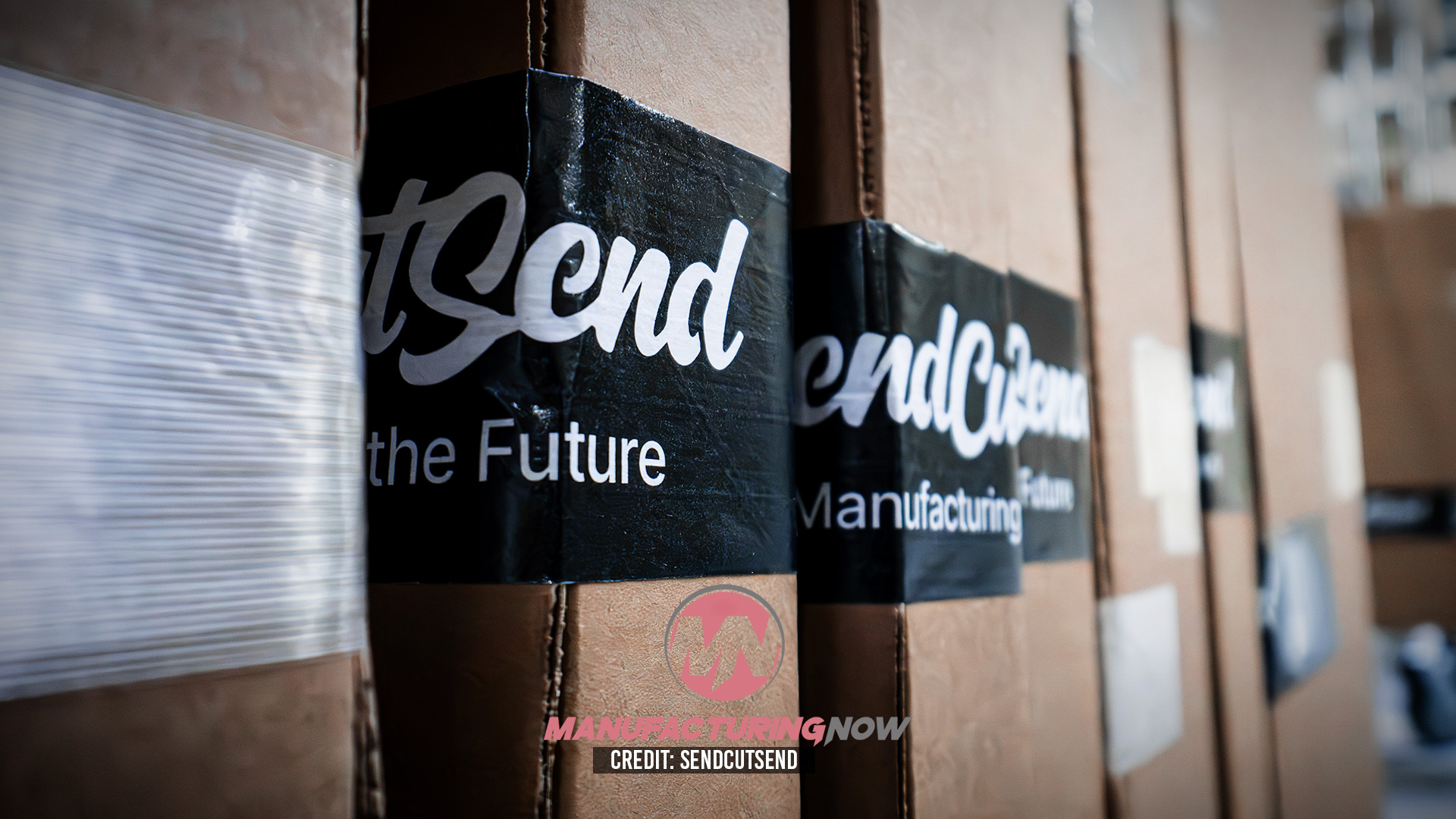 Cardboard shipping boxes with 'Trend' branding and black label bands featuring manufacturing text
