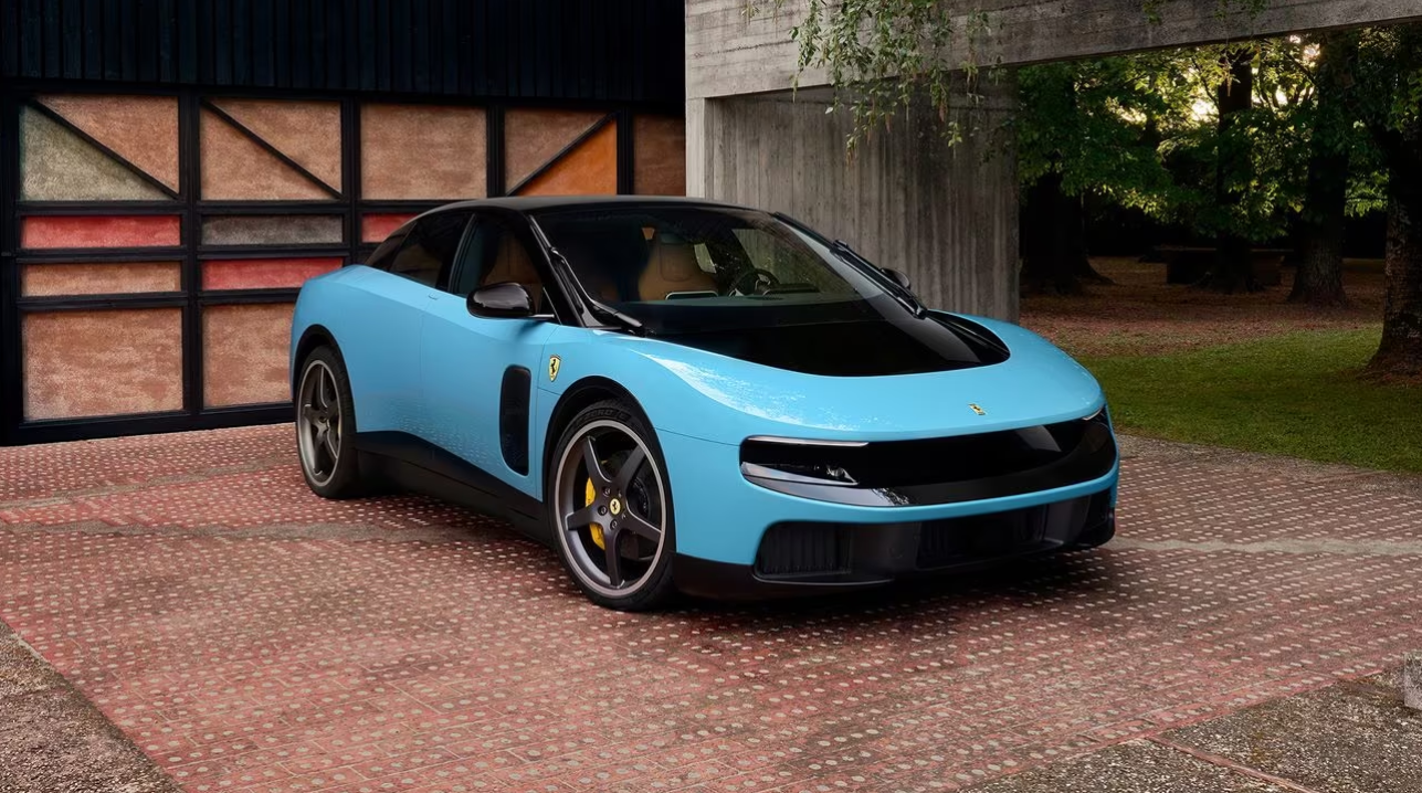 Bright blue Lotus Emira sports car parked on brick driveway beside Tudor-style building