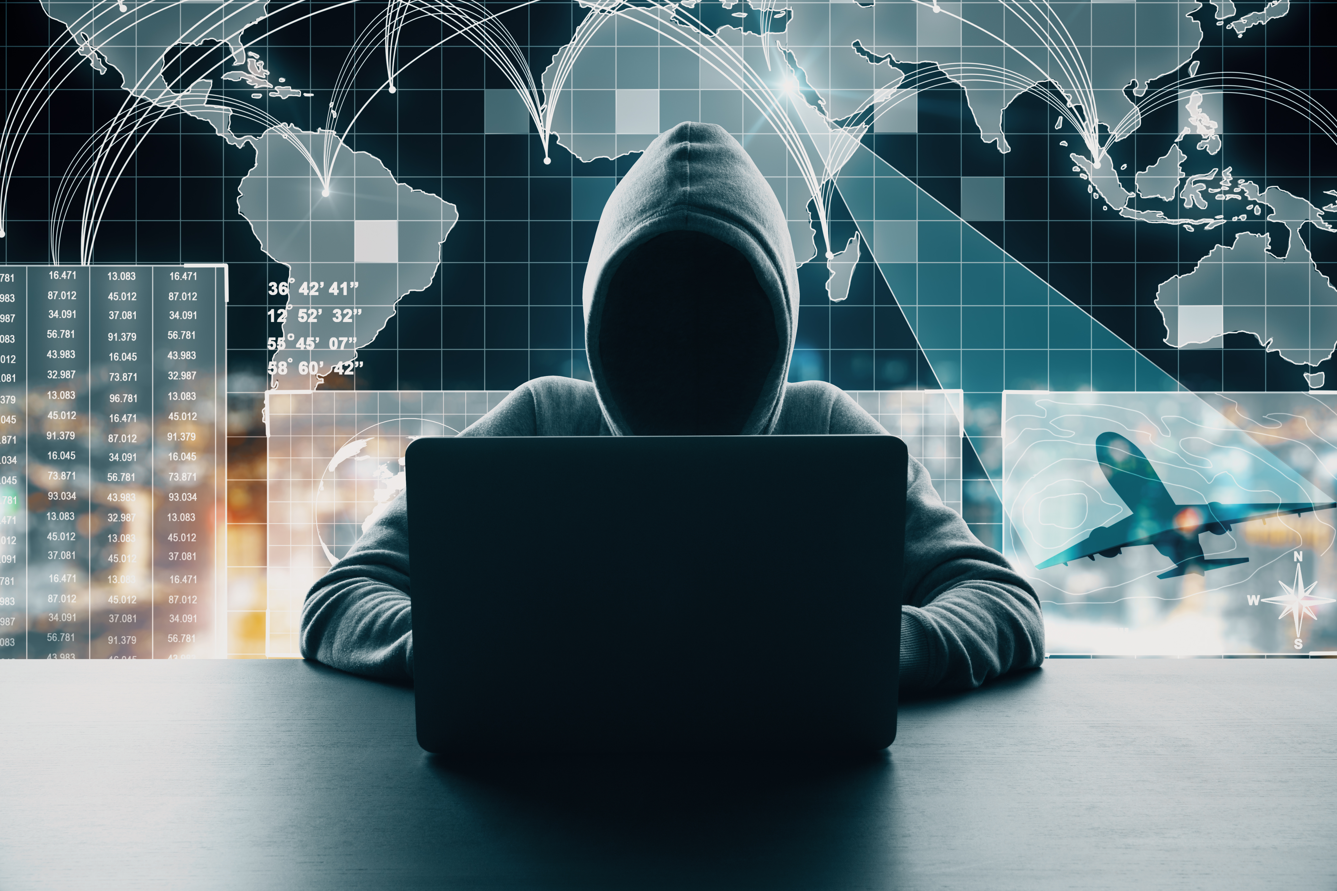 Hooded figure at laptop with world map, network connections, and financial data visualizations representing cybersecurity and global digital threats