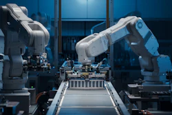 Industrial robotic arms operating on an assembly line with blue ambient lighting in a modern manufacturing facility