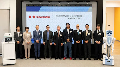 Ten business professionals stand in formal attire at Kawasaki Physical AI Center San Jose opening event, flanked by robotic equipment.