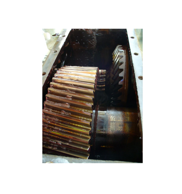 Stack of CDs and DVDs stored in a dark container with metal hardware visible