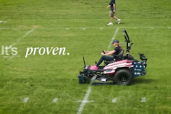 Person operating American flag-themed zero-turn mower on grass field with 'It's proven' text overlay