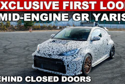 Camouflaged Toyota GR Yaris prototype mid-engine sports car in parking lot with exclusive first look text overlay