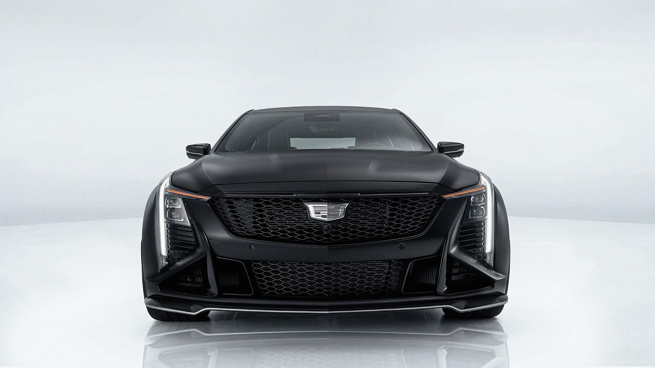 Black Cadillac luxury sedan front view with distinctive grille and LED headlights on white background