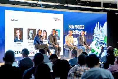 Panel discussion at 5th MOBIS Mobility event featuring speakers discussing sustainable transportation solutions