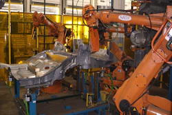 Industrial robotic welding arms with NACHI equipment at manufacturing facility workstation