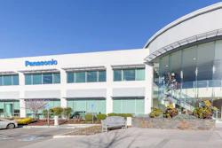 Panasonic corporate office building with modern white facade and curved glass entrance under clear blue sky