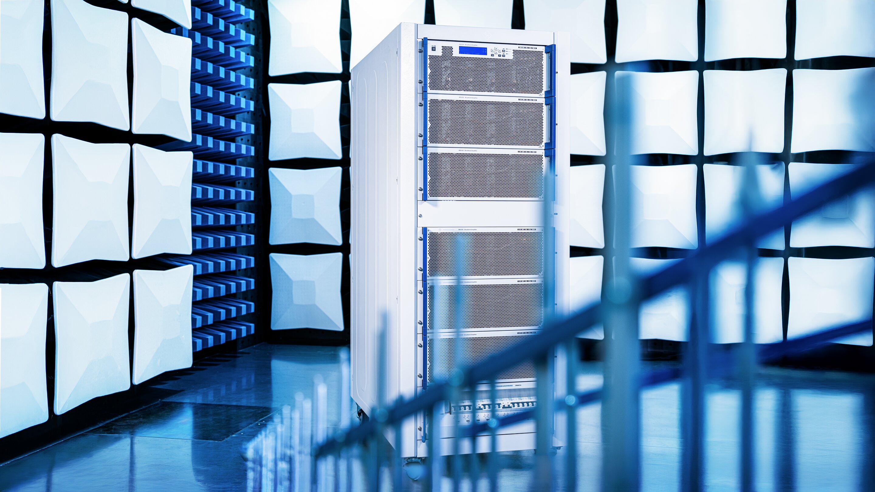 Modern data center with server racks and glass architecture in blue-toned lighting