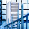 Modern data center with server racks and glass architecture in blue-toned lighting