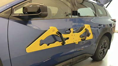 Yellow door edge guard protector attached to blue vehicle door for impact protection