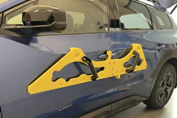 Yellow door edge guard protector attached to blue vehicle door for impact protection
