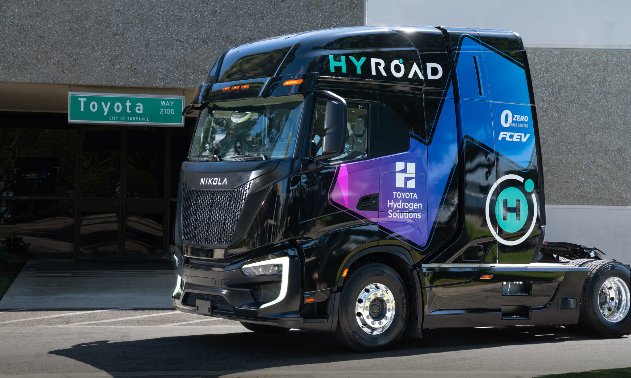 Blue hydrogen fuel cell truck with HYROAD branding and Toyota Hydrogen Solutions livery parked at facility