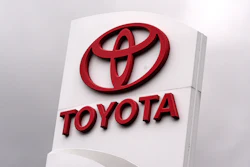 Toyota logo and text on white exterior signage with 3D red lettering