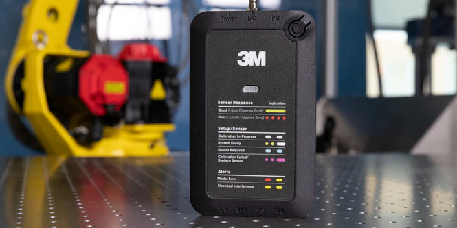 3M sensor monitoring device with status indicators on laboratory workbench with industrial equipment