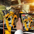 Augmented reality interface displaying industrial robotic arms with control panels and operational overlays in a warehouse setting