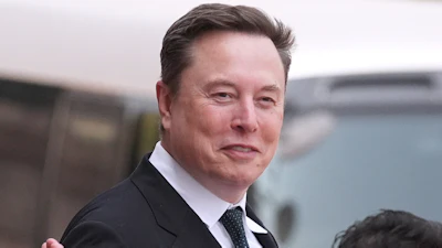 Professional man in dark business suit and tie gesturing while speaking outdoors