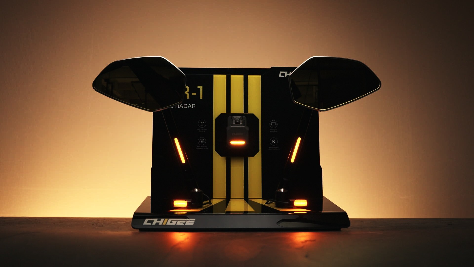CHIDEZ gaming device with black wings, gold center stripe, and orange LED lighting on dark surface