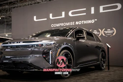 Lucid electric SUV displayed at automotive showroom with 'Compromise Nothing' brand tagline on backdrop