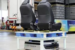 Black car seats displayed on blue and white platform with Geek+ branding in industrial warehouse setting