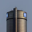 GM logo on cylindrical corporate tower against blue sky