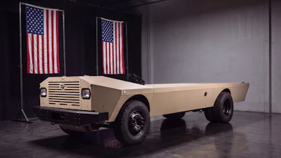 Vintage International Harvester truck displayed in showroom with American flags