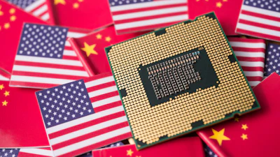 Computer processor chip on American and Chinese flags symbolizing technology trade relations