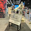 Kawasaki Pano Sealing Robot on display at an industrial trade show with visitors in background