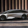 Silver Lexus LF-Z concept electric vehicle displayed in profile against modern columned architecture