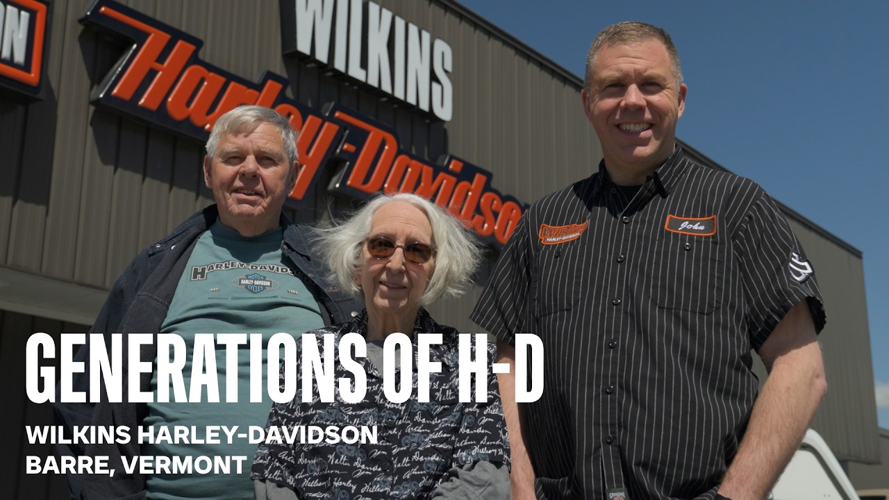 Three generations of Harley-Davidson enthusiasts stand together outside Wilkins Harley-Davidson in Barre, Vermont