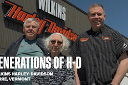 Three generations of Harley-Davidson enthusiasts stand together outside Wilkins Harley-Davidson in Barre, Vermont