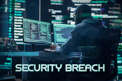 Developer monitoring code on multiple screens with security breach alert overlay in dark tech environment