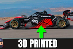 Red and black 3D printed race car model with sponsor logos displayed on mountain landscape background