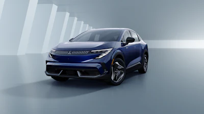 Blue Peugeot 3008 electric SUV displayed in a modern studio setting with geometric white architectural backdrop