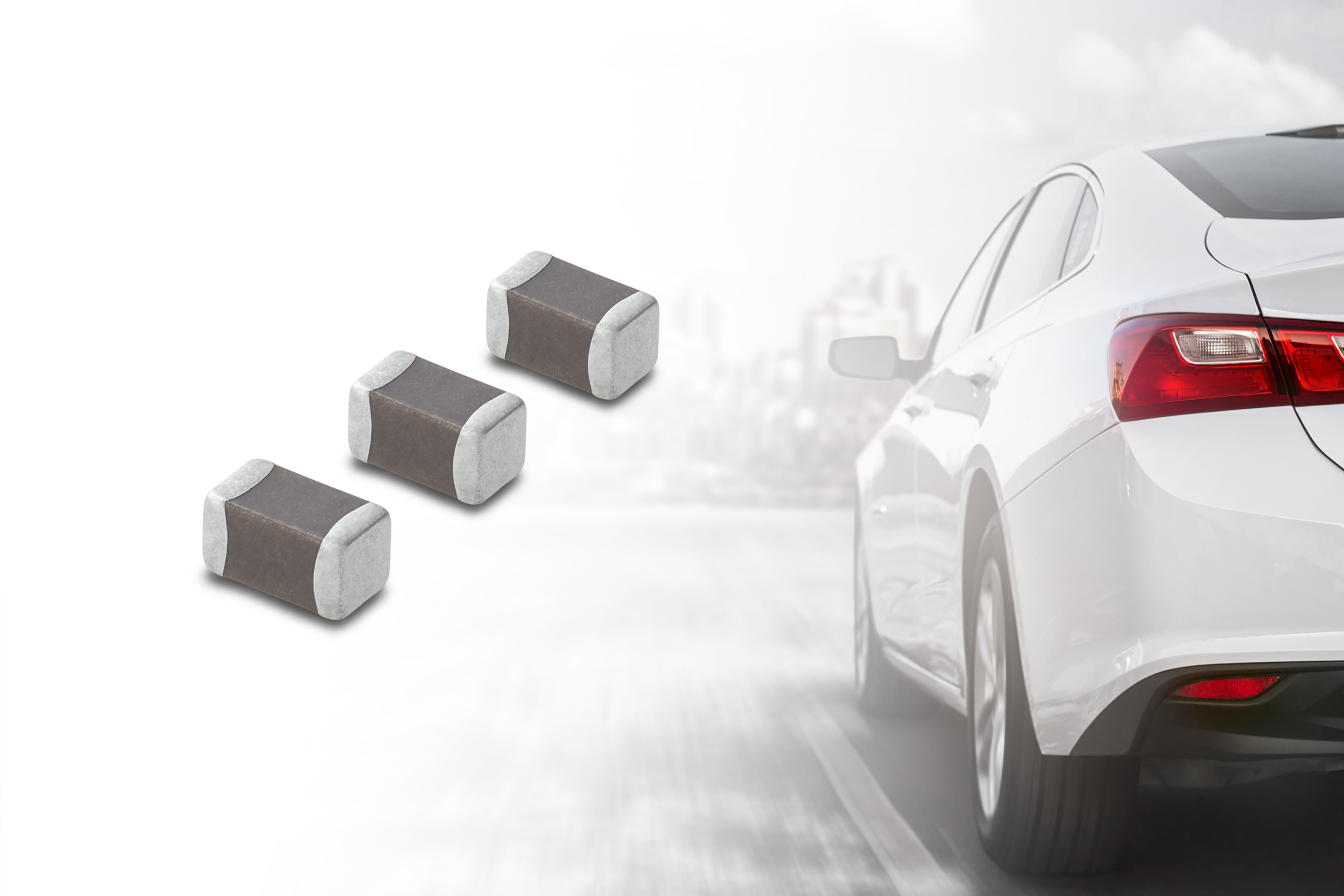 Three surface-mount electronic components displayed next to a white sedan with red taillights