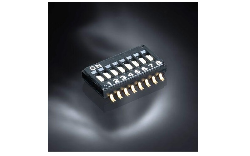 Black DIP switch module with 8 toggle switches and gold pin connectors on dark background