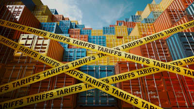 Stacked shipping containers at port with yellow caution tape labeled 'TARIFFS' symbolizing trade restrictions and import costs.